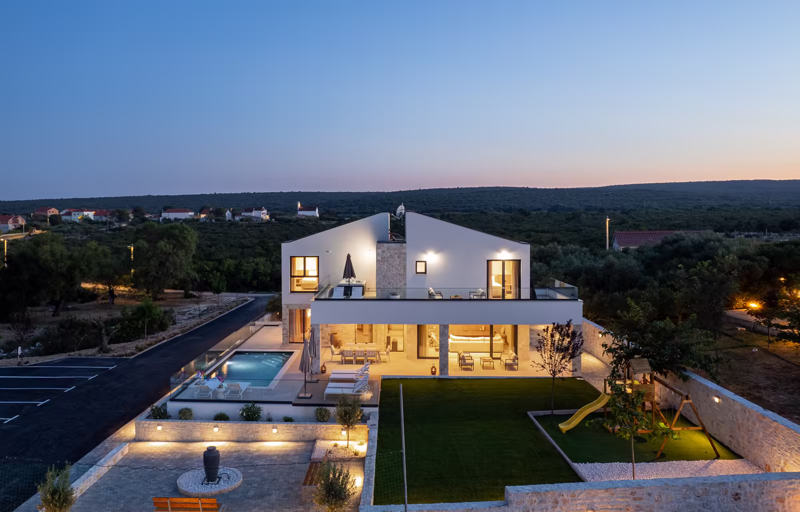 Aerial view of family villa with pool and gardens