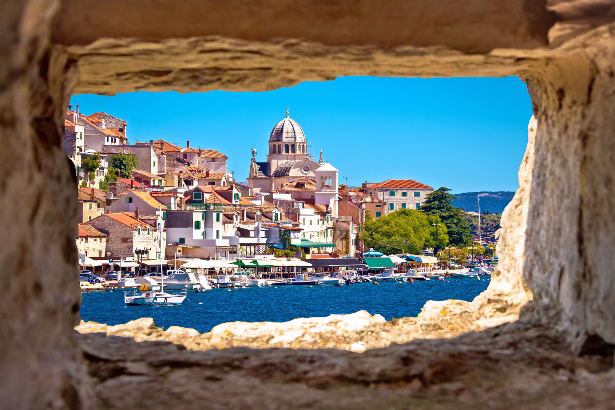 Šibenik old town and Cathedral of St James viewed through a stone window